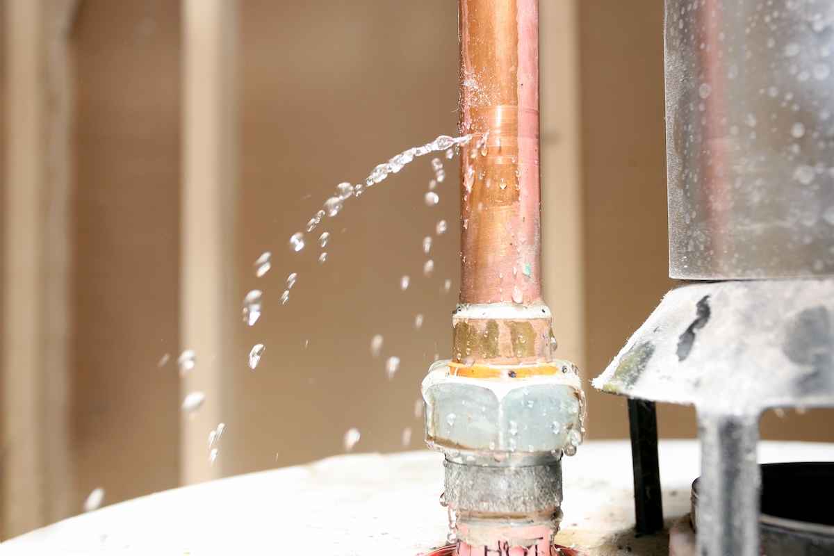Water leaks from a copper pipe.