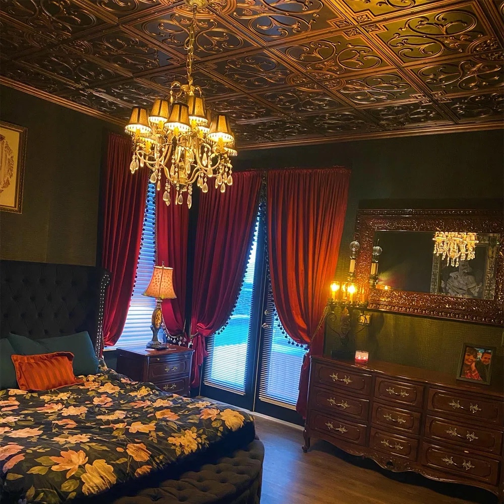 Room with ceiling covered in copper tiles