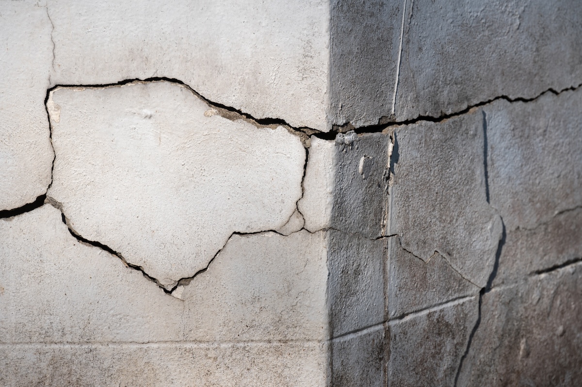 A house with cracks in its cement foundation.