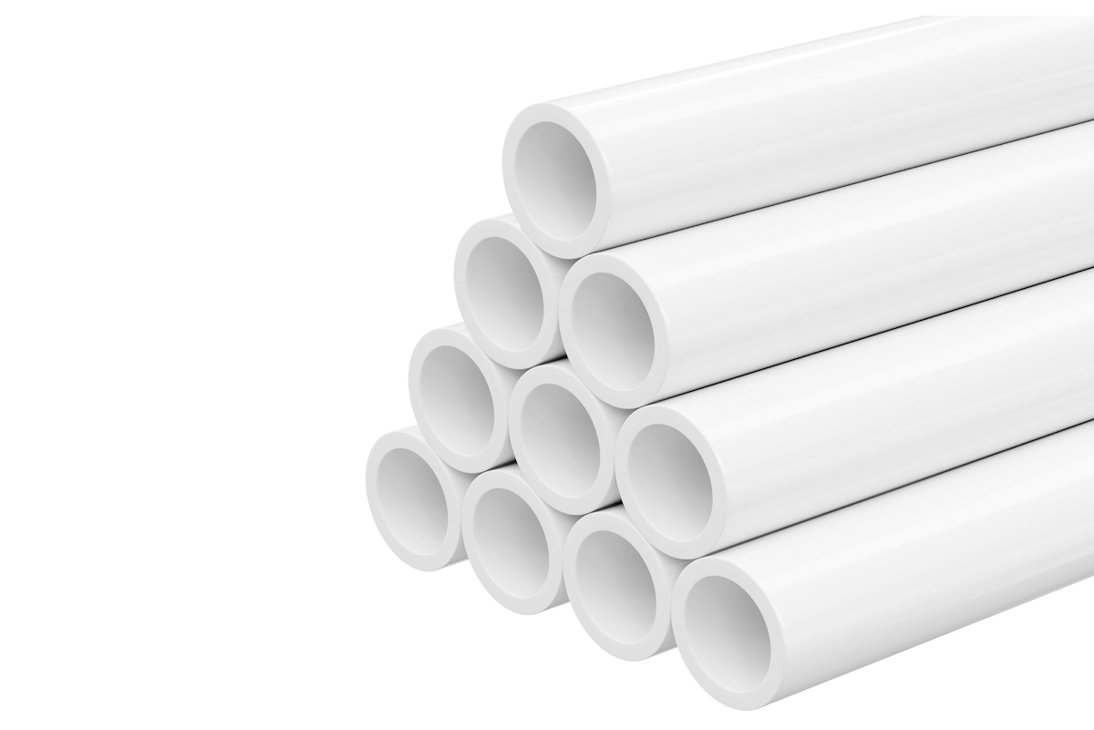 A pile of white PVC piping used for plumbing. 