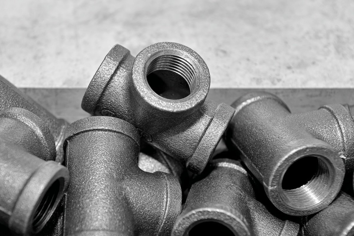Black iron T joint piping components for plumbing systems.