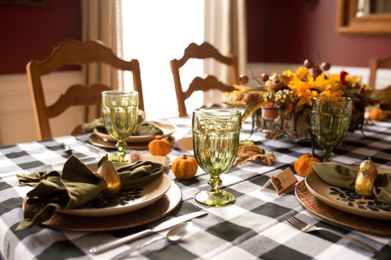 A festive dining table decorated for Thanksgiving.