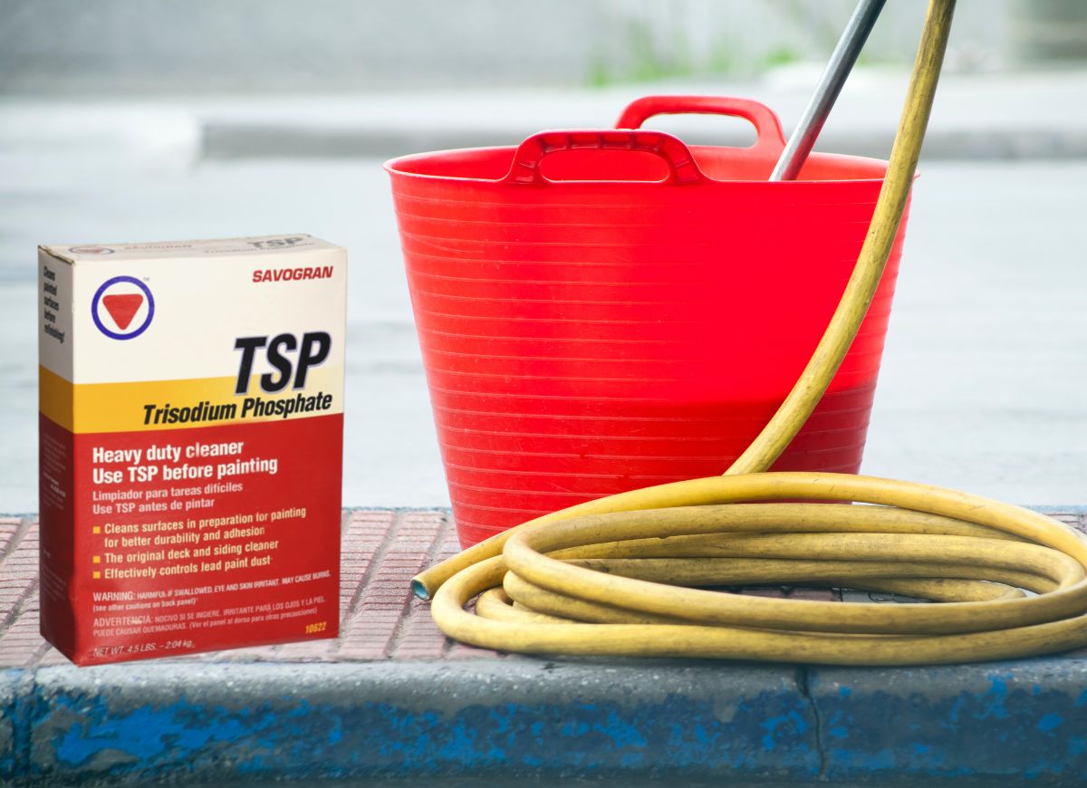 Amazon trisodium phosphate box of trisodium phosphate next to a bucket with a hose in it