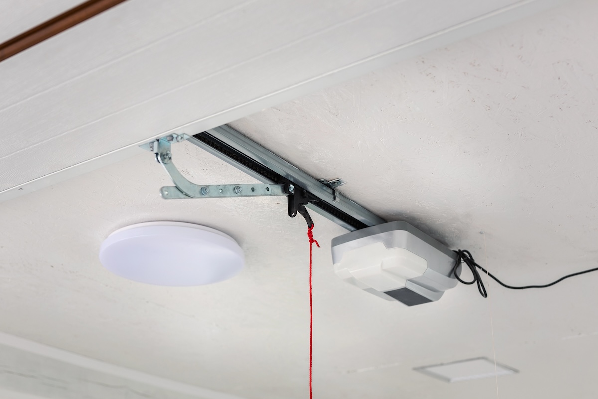 A red emergency cord hangs from a garage door system.