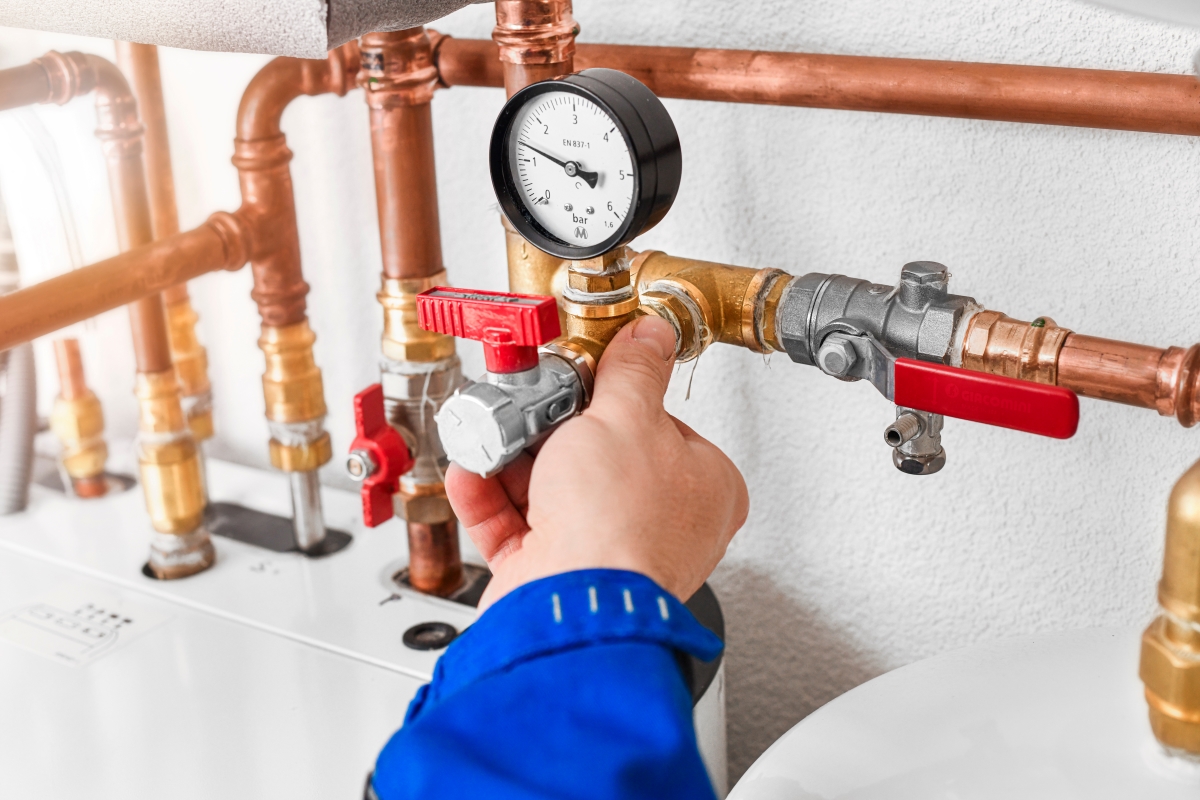 A person holding water pressure valve.