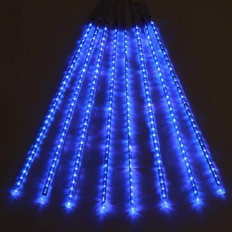  A set of the Twinkle Star Meteor Shower Rain Lights in blue on a dark background.