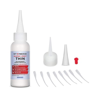 Bottle of Starbond EM-02 Super Fast Thin CA Glue next to multiple tops on a white background