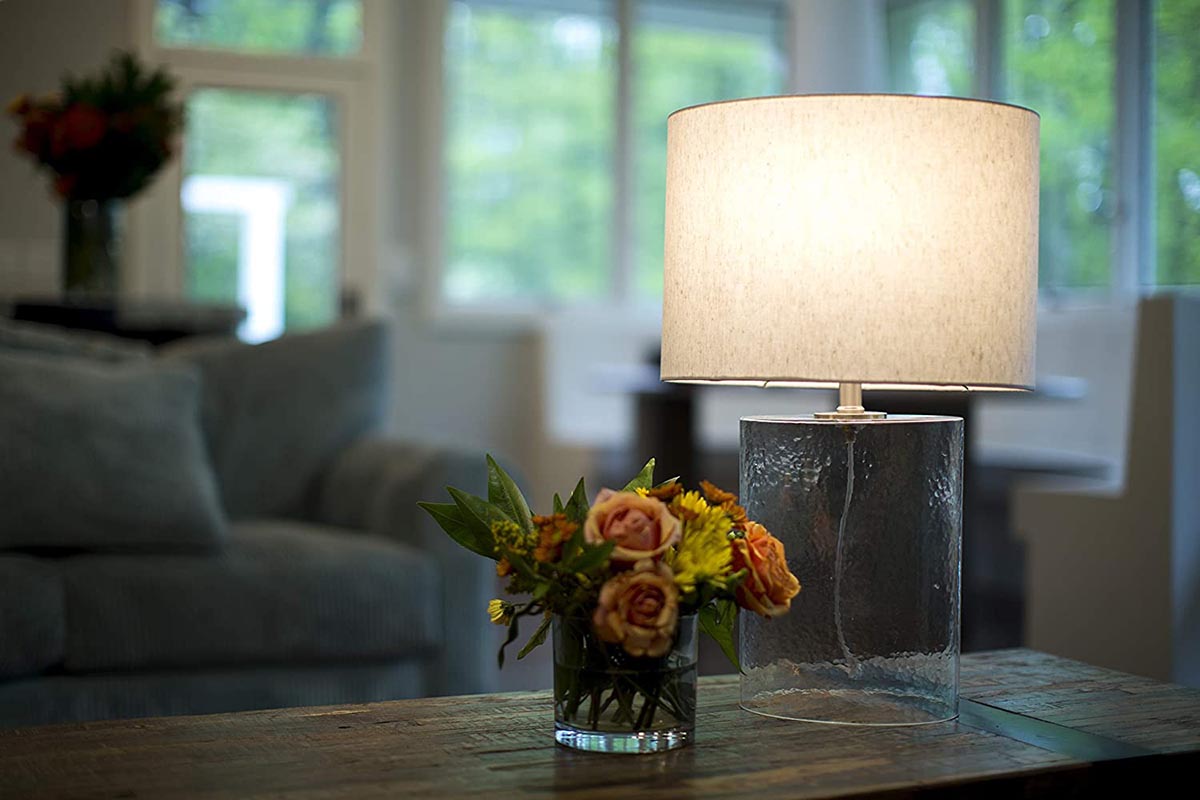 The Best LED Light Bulb Options in a lit lamp on a living room coffee table