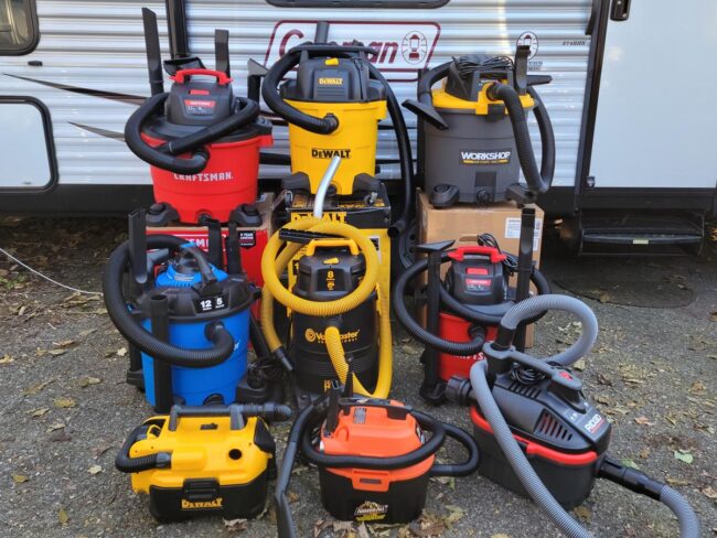 A group shot of the best wet/dry vacuums outside next to a camper