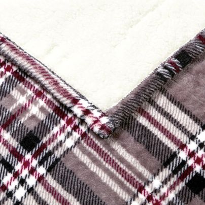 The Beautyrest Heated Snuggle Wrap Electric Blanket with its plaid side up and one corner folded over to show its soft white underside.