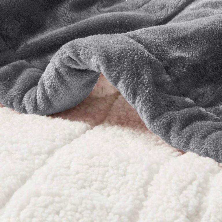  The Degrees of Comfort Fuzzy Sherpa Heated Blanket displayed to show both its sides: soft grey and fuzzy white.