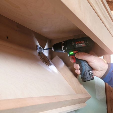  Bosch PS31-2A 12V MAX ⅜-Inch Drill/Driver Kit drilling under a wood table
