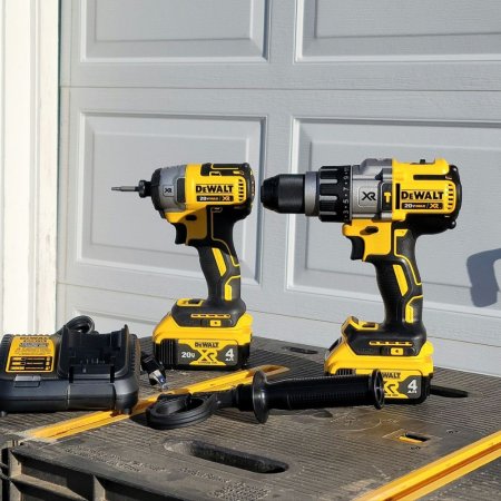  2 DeWalt DCK299M2 20V MAX Hammerdrill & Impact Drivers on a workbench