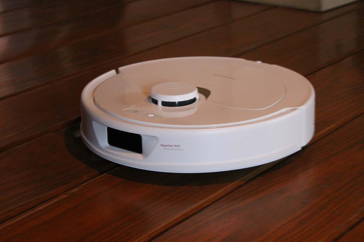 White circular robot mop clean hardwood floor