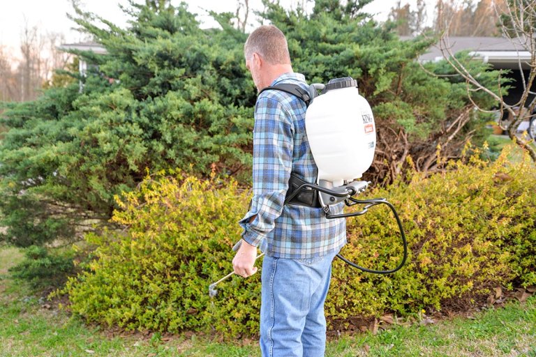 A product testerrusing the Field King Max Backpack Sprayer
