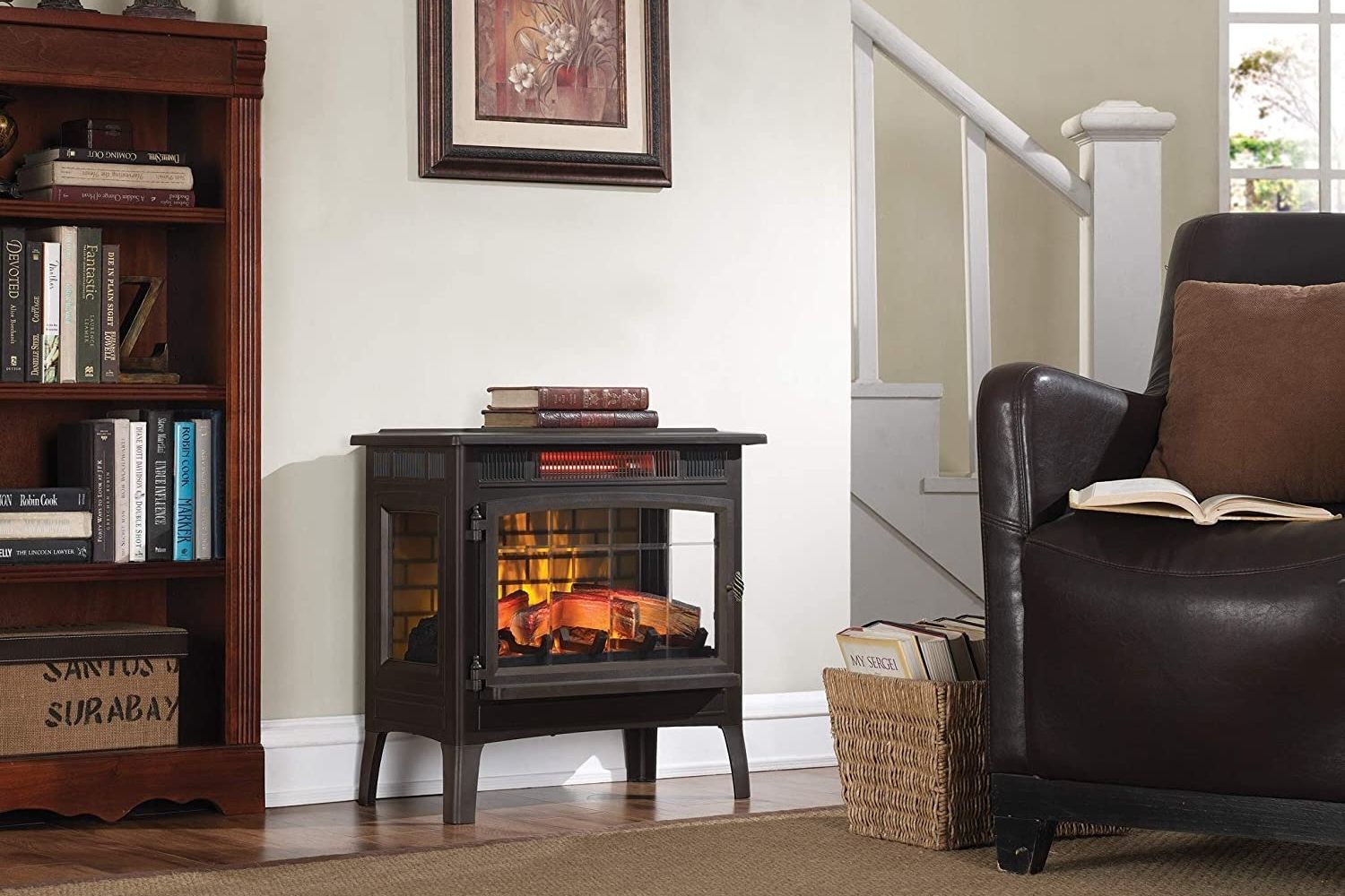 The best electric fireplace stove option with a fire going in a living room next to a recliner