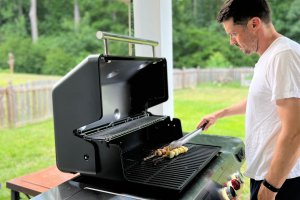 A product tester rotating kabobs on one of the best Weber grills during testing