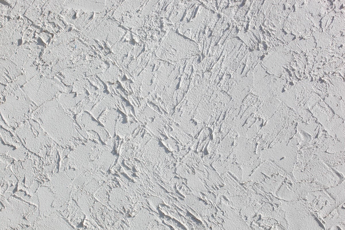 A white wall textured with the slap brush knockdown method.