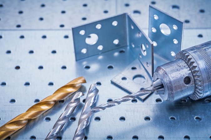 The best drill bits for metal options next to a close-up of a drill and metal hardware