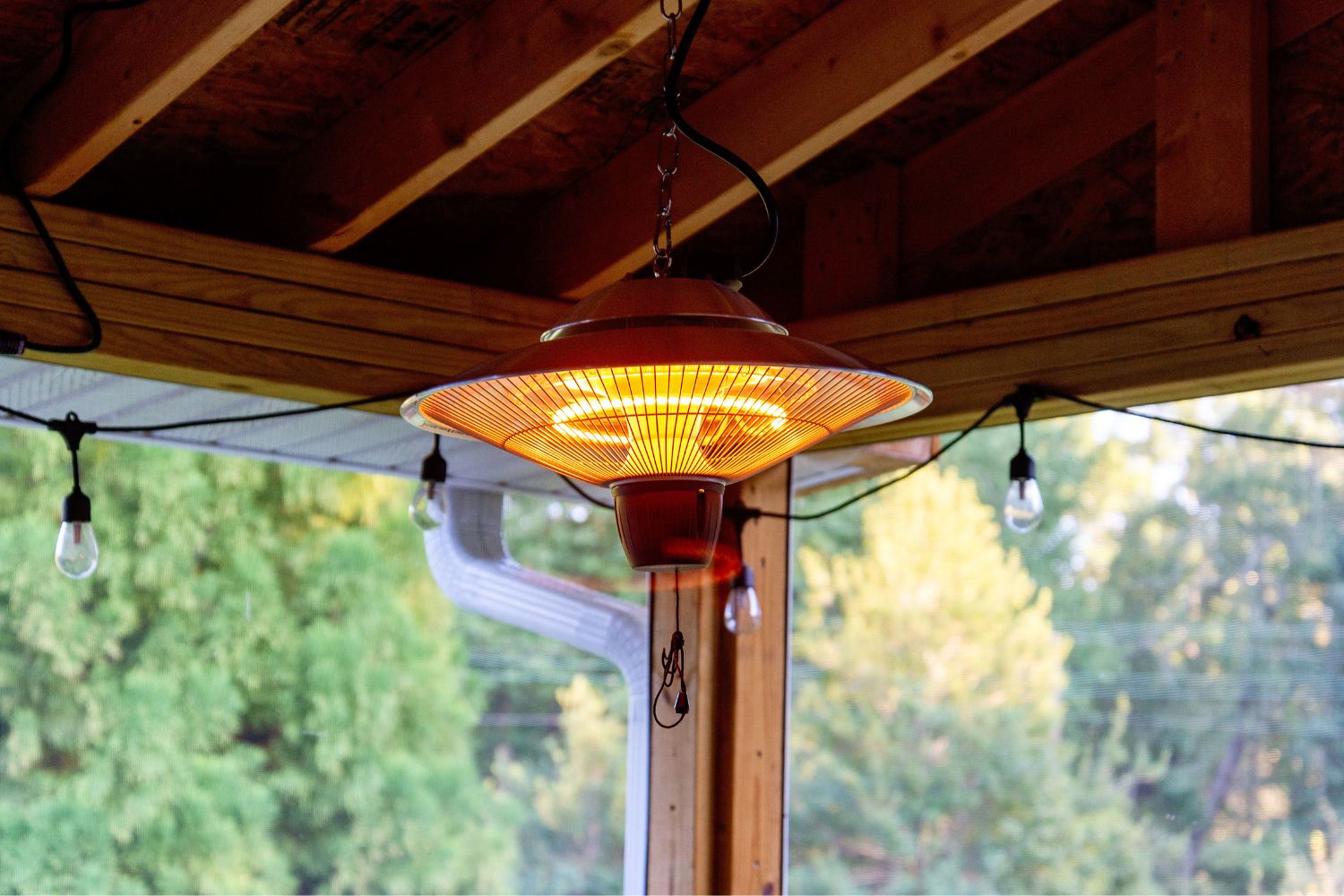 The best patio heater option glowing with warmth on the corner of an outdoor patio.