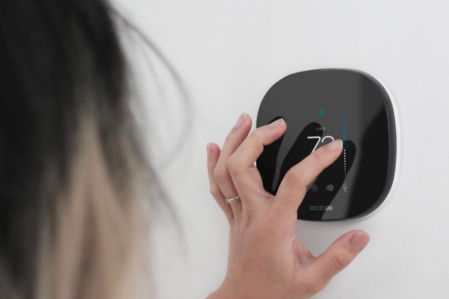 A person using their finger to adjust the best programmable thermostat option