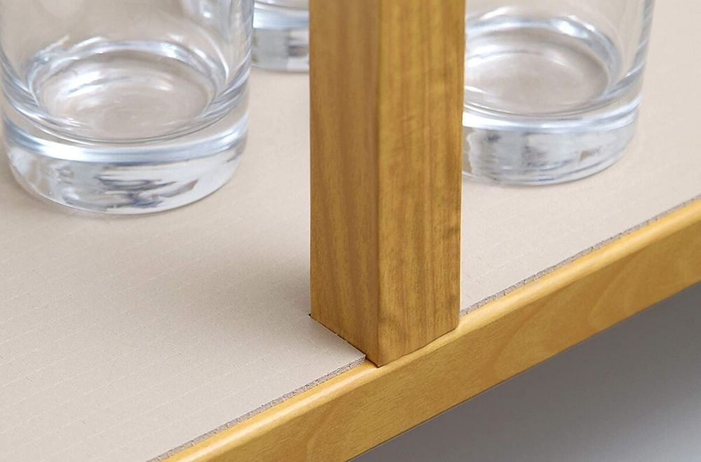 The best shelf liner installed in a kitchen cabinet with drinking glasses on it.