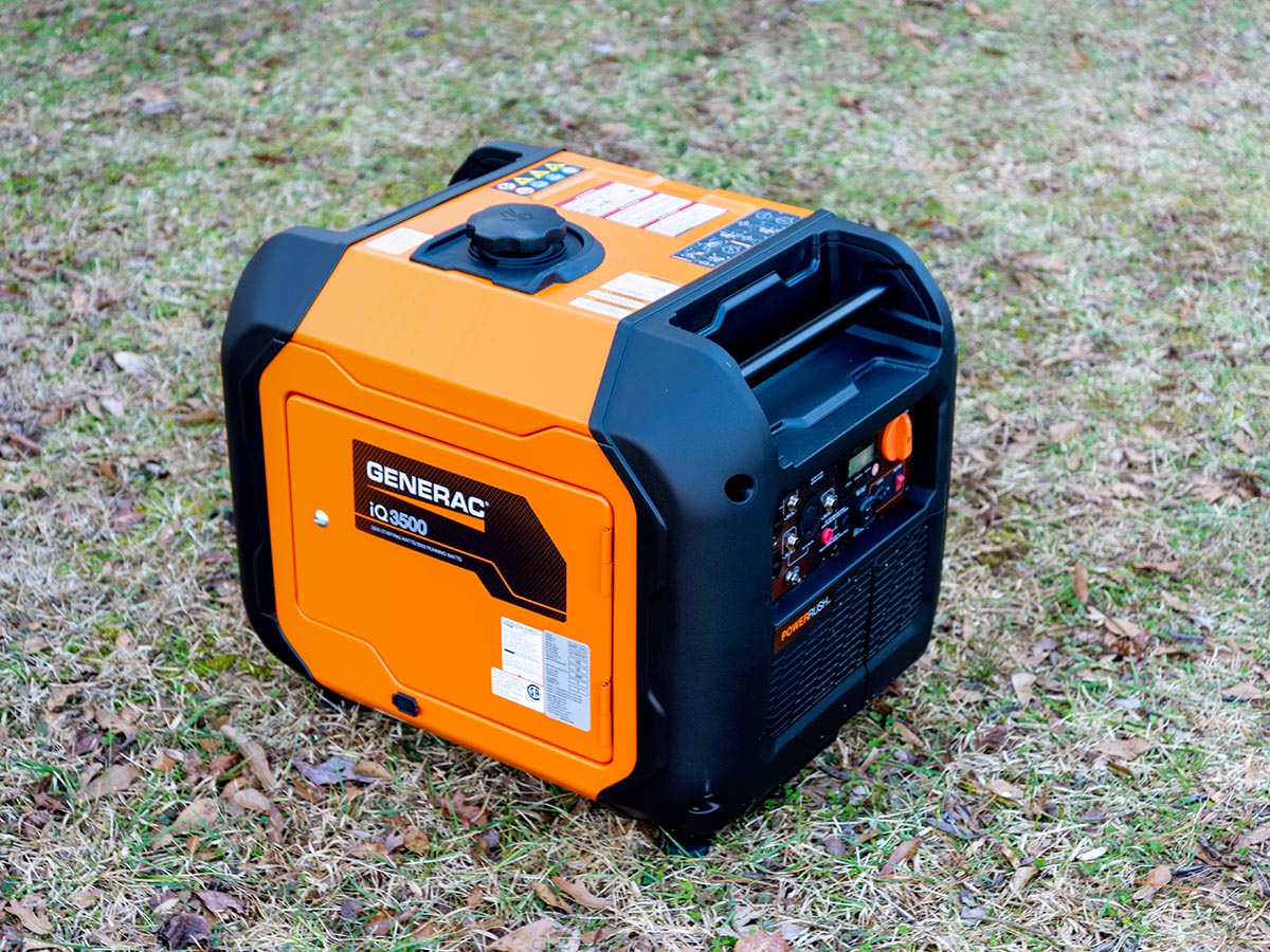 Orange and black Generac iQ3500 portable inverter generator on grass