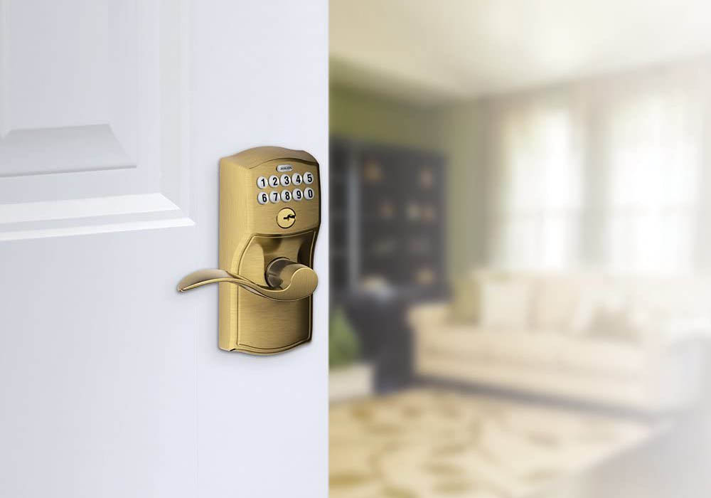 The best keypad door locks option in the foreground with the door its attached to open to reveal an interior living room