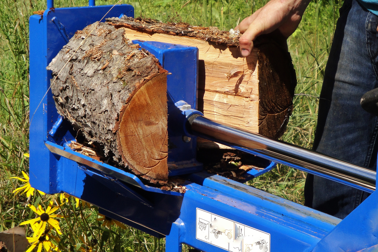 The best log splitter for splitting firewood in use splitting a round down the middle.