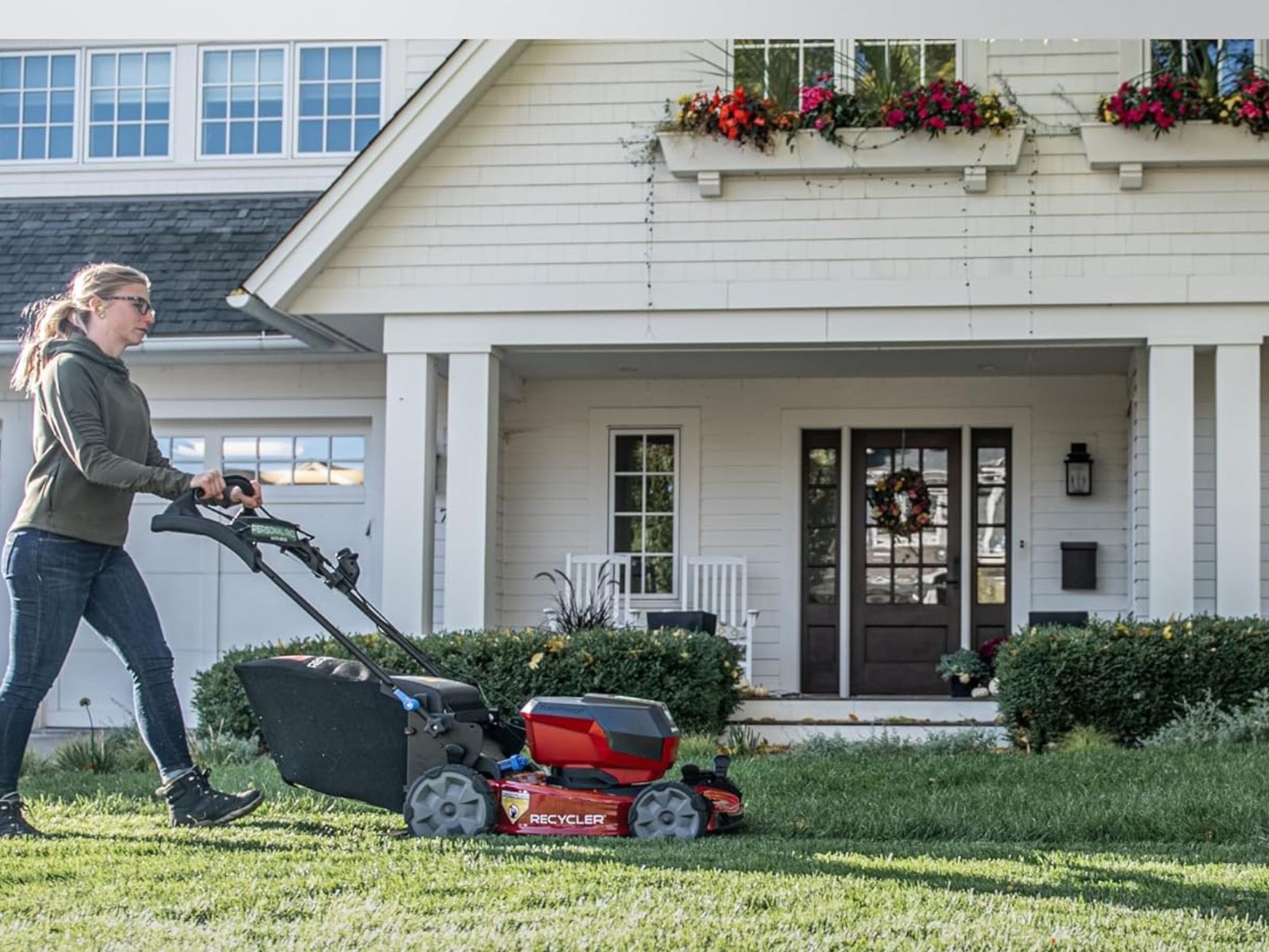 a woman using one of Best Self-Propelled Lawn Mower ptions