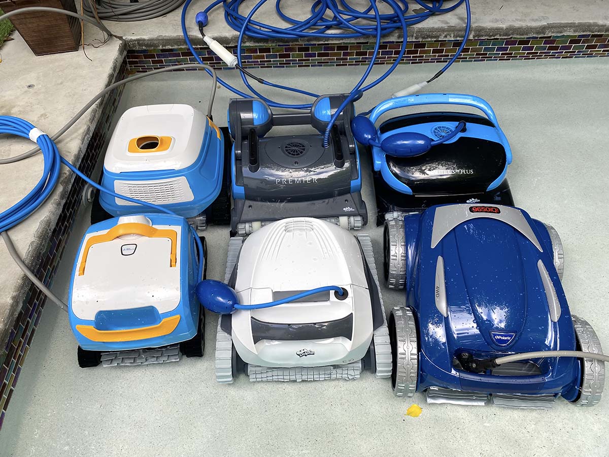 A group of the best robotic pool cleaner options together next to a pool