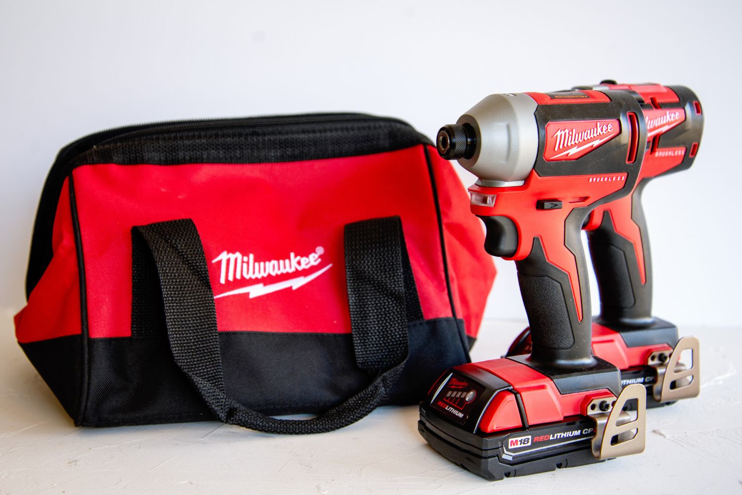 The Milwaukee M18 18V 6-Tool Combo Kit next to its carry bag on a white background.
