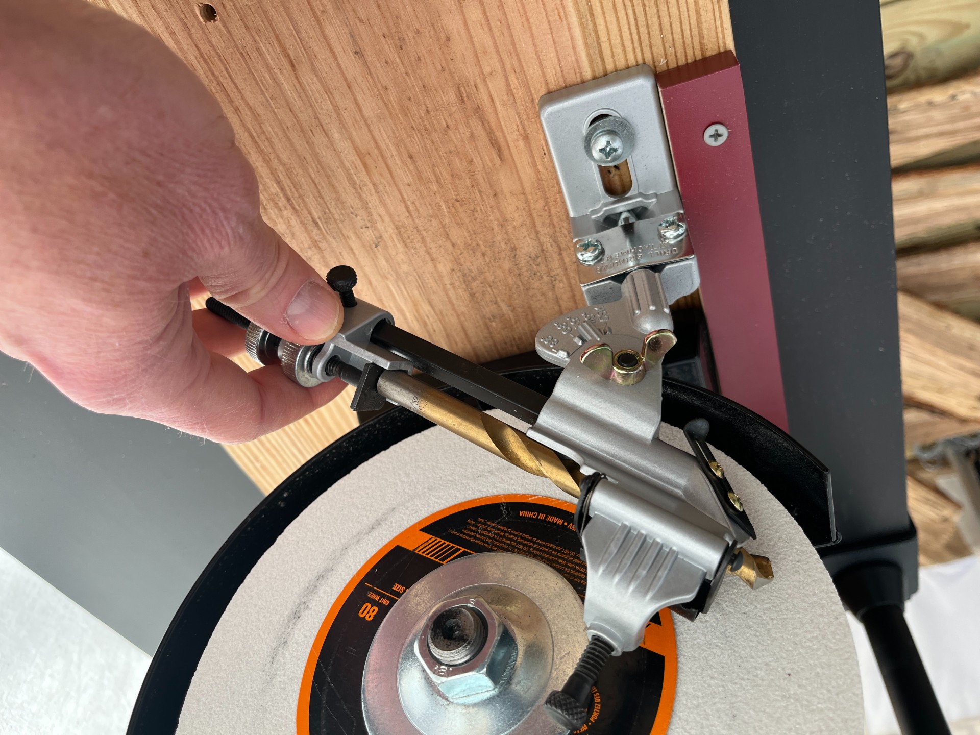 a person working with General Tools drill sharpening jig