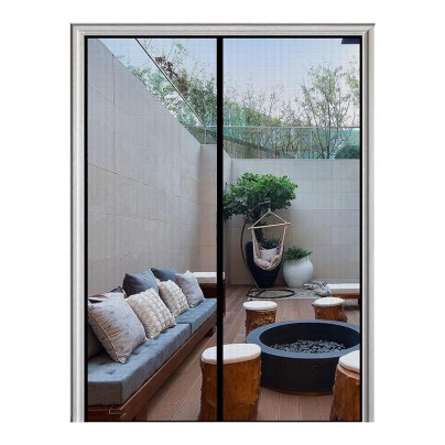 Looking through the Homearda Magnetic Screen Door at a well-appointed outdoor patio.