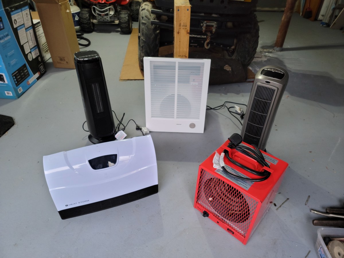 A group of the best electric garage heaters together on a garage floor before testing.