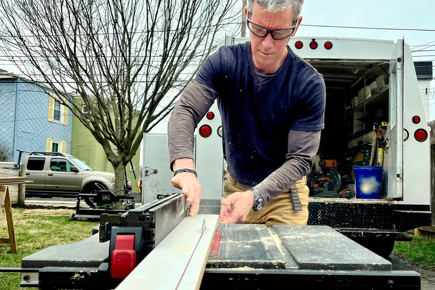A person using the best table saw blade to cut a long board
