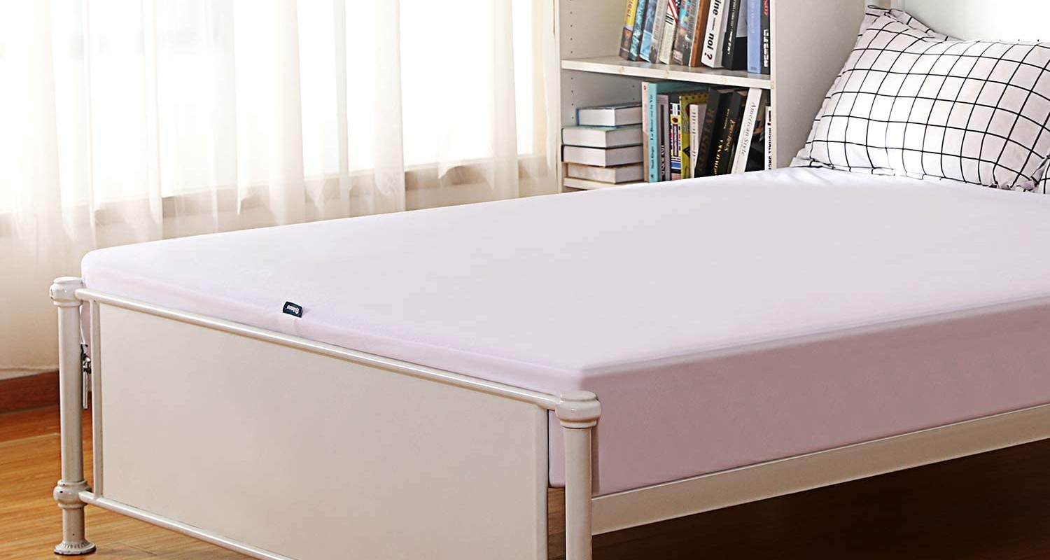 The best mattress pad option covering a mattress in a bedroom
