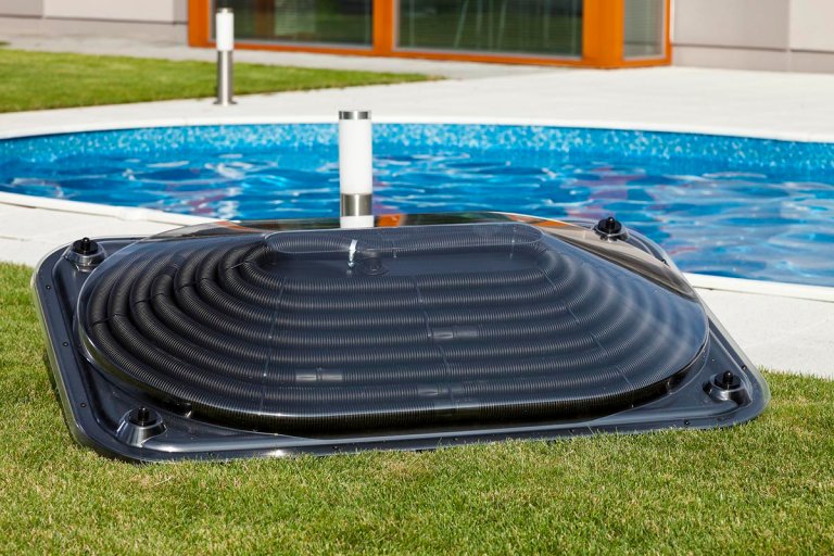 The Best Pool Heater Option on the grass next to a pool