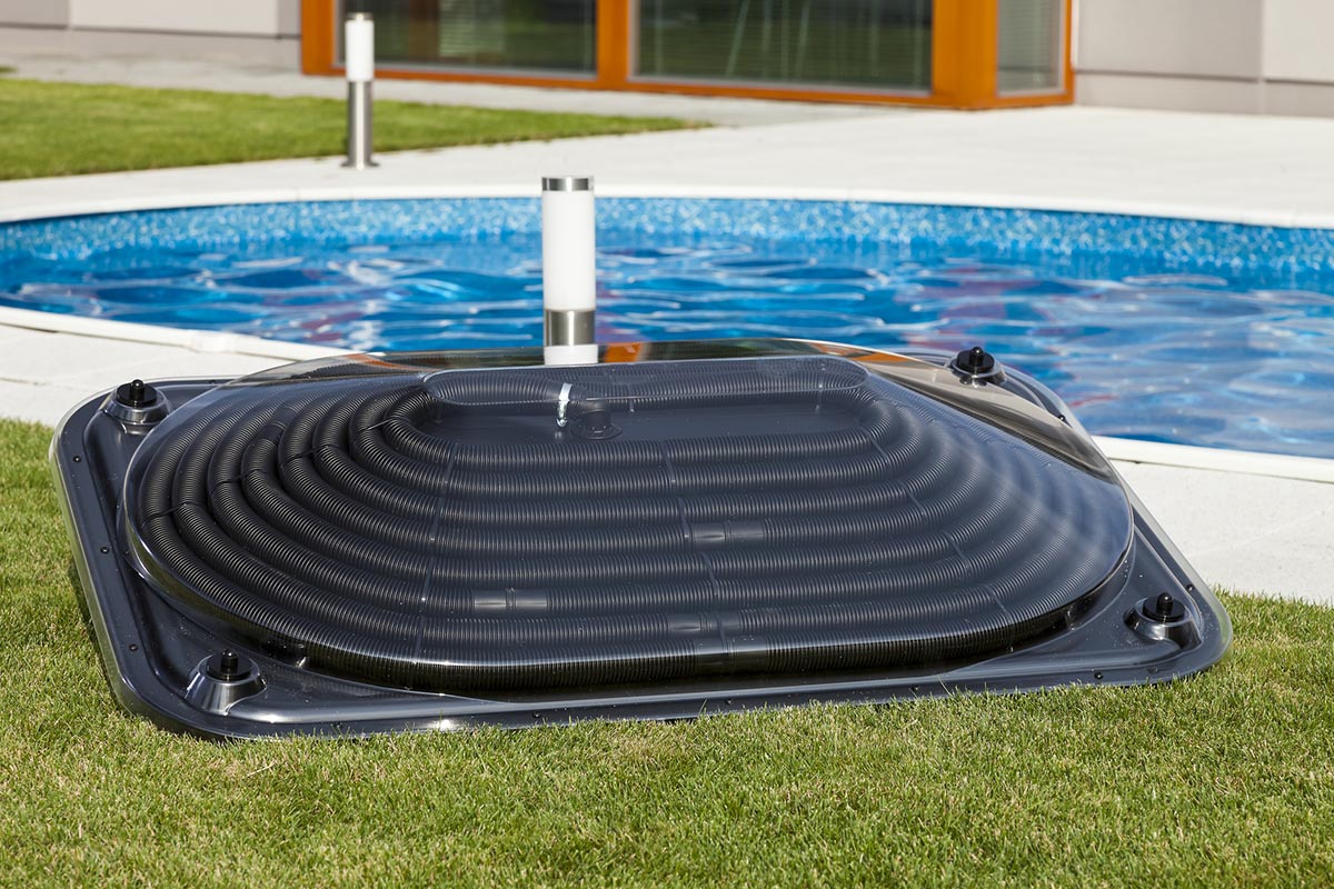 The Best Pool Heater Option on the grass next to a pool