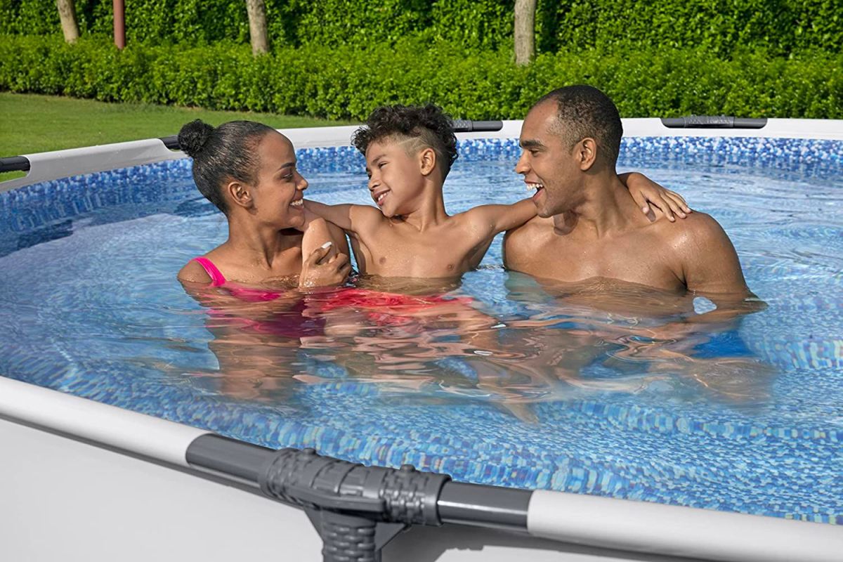 A family of three enjoying the best above-ground pool option