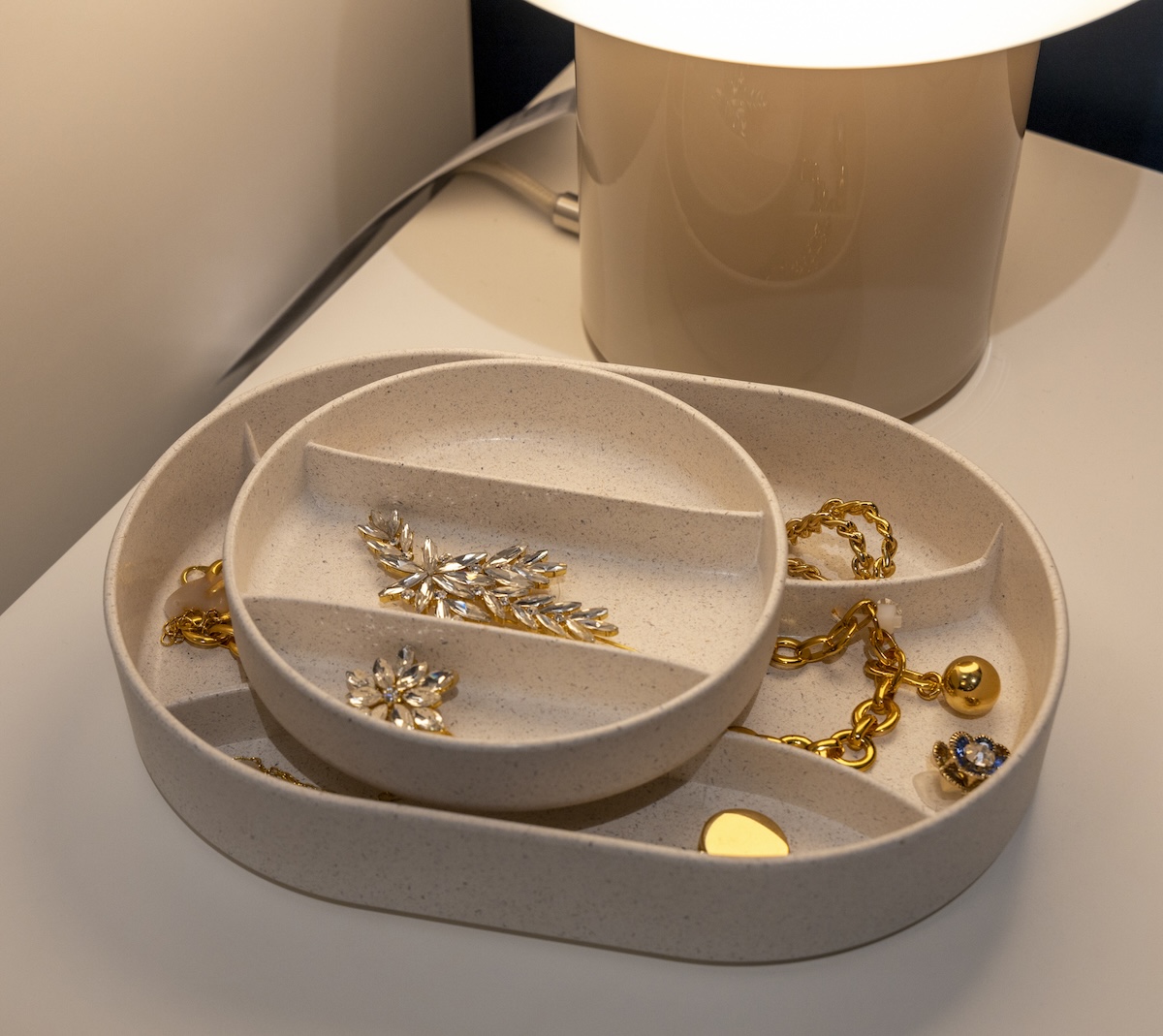 A small storage box containing expensive jewelry sits ajar on a bedside table.