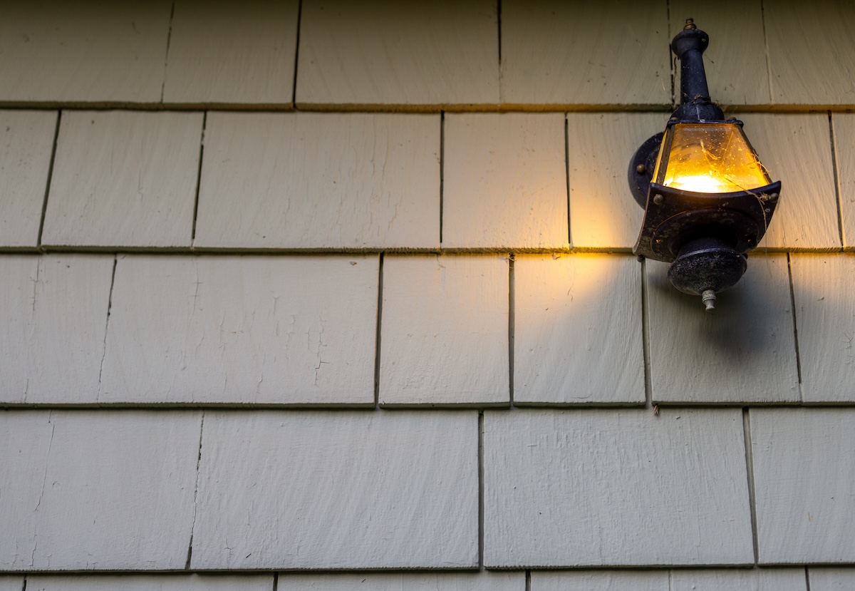 A rustic motion sensor light on a home.