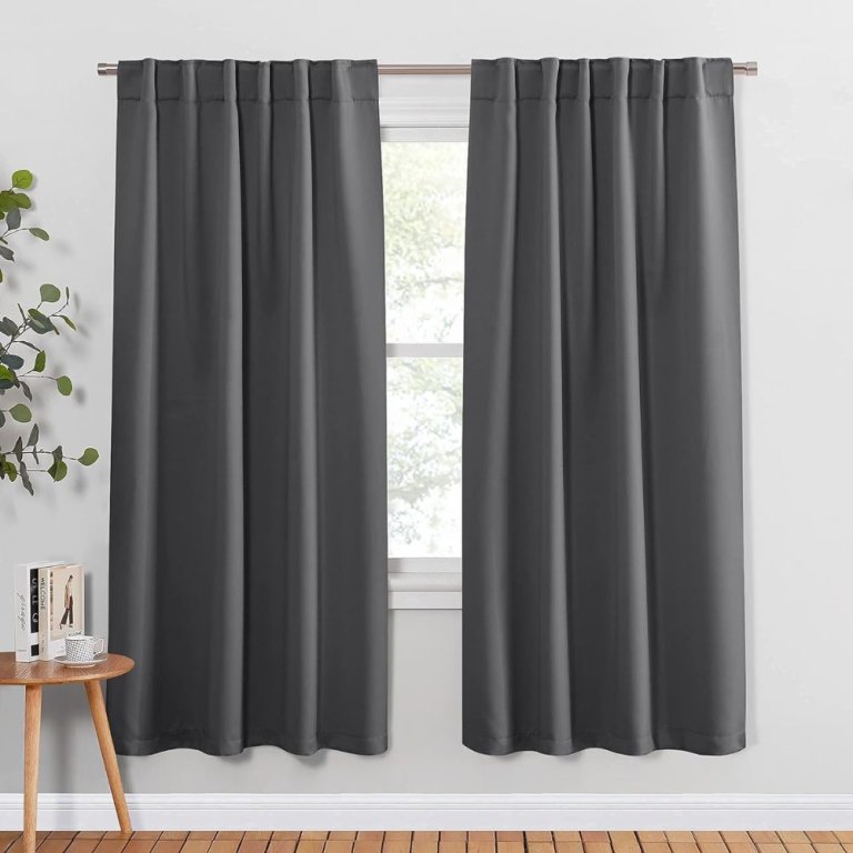 A pair of grey Pony Dance Blackout Curtains covering a living room window.