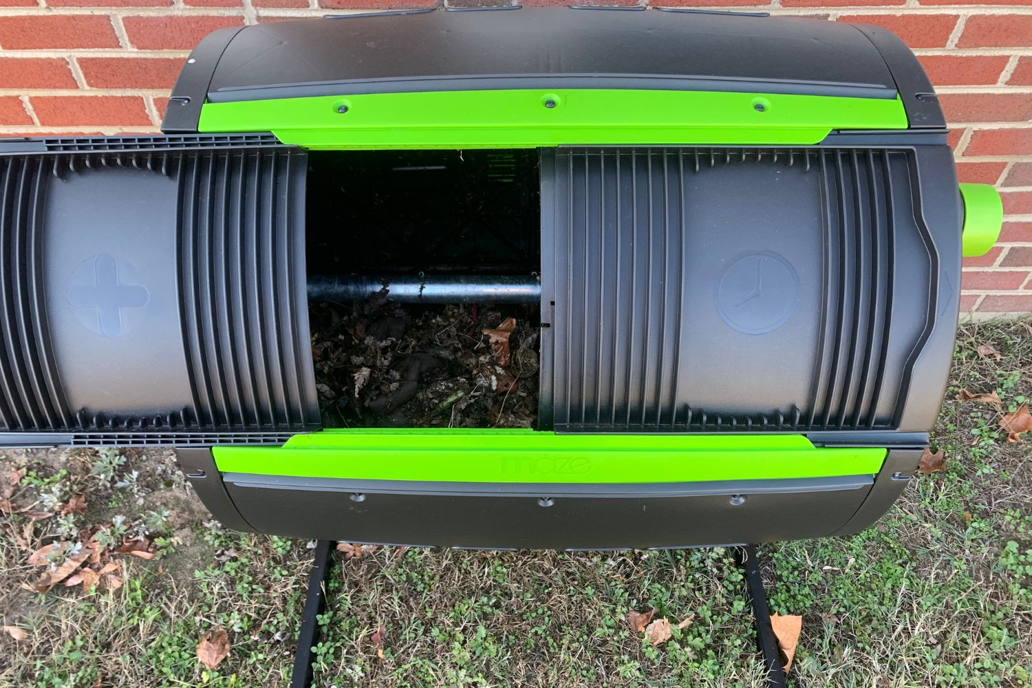 The best compost tumbler option from above with its door open to reveal composting materials