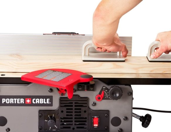 A person using the best jointer to smooth and flatten the face and edge of a piece of stock lumber.
