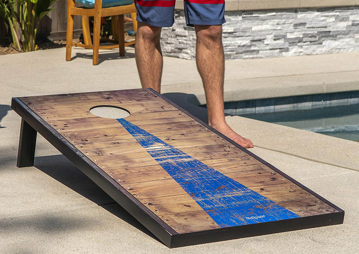 The Best Cornhole Board Option set up next to a pool