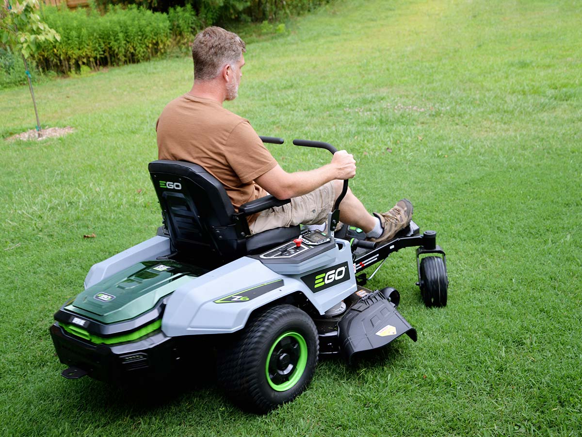 A person using the best riding mower option to mow a very large yard