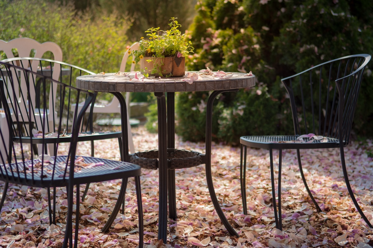 Fall patio furniture covered in leaves.