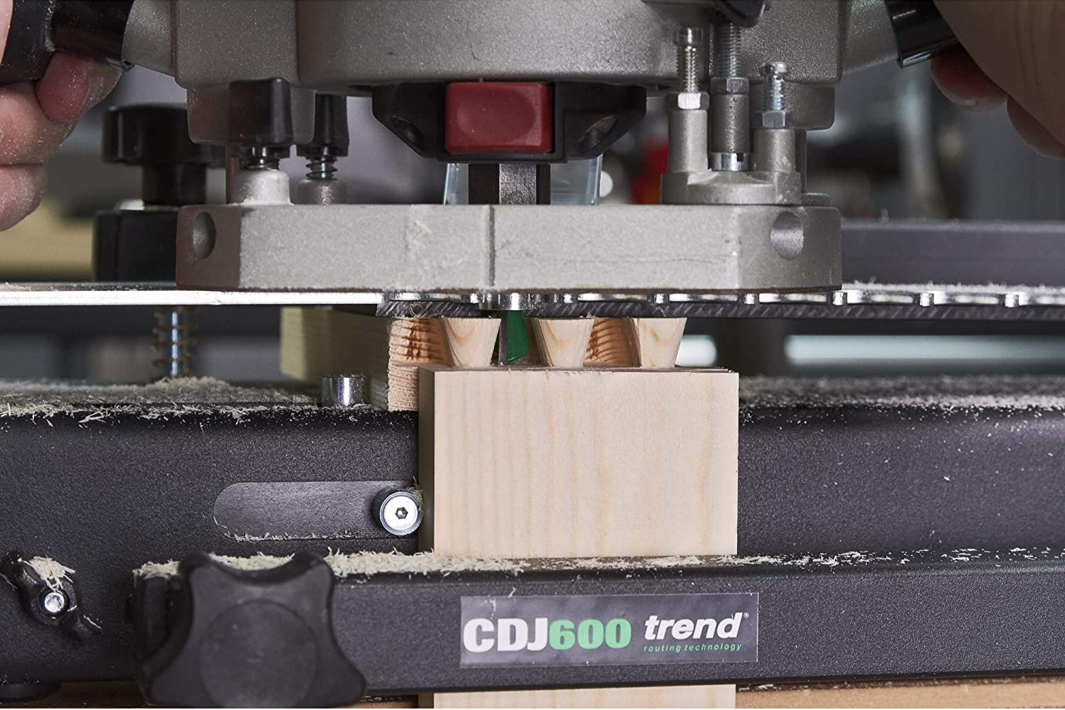 The Best Dovetail Jig in use creating a dovetail joint on a light piece of wood.