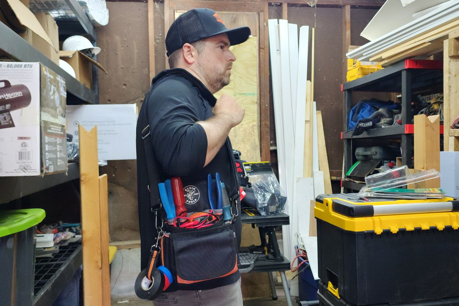 Man holding a Klein Tools electrician tool belt
